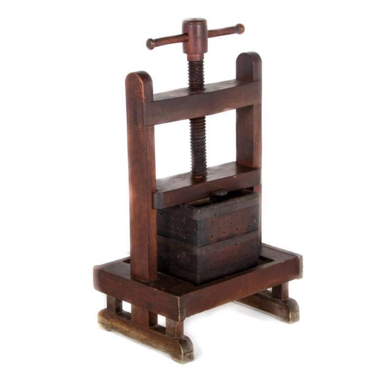 This antique French solid walnut wine press is an interesting and decorative architectural object, with great patina and character.

