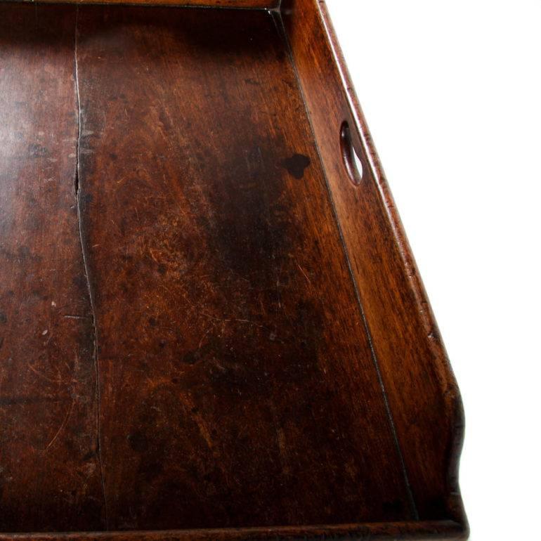 Mid 19th century antique English butlers tray, constructed of solid mahogany. Note large crack through the middle from shrinkage due to age. Integrity of the piece is not compromised by the crack, circa 1850.