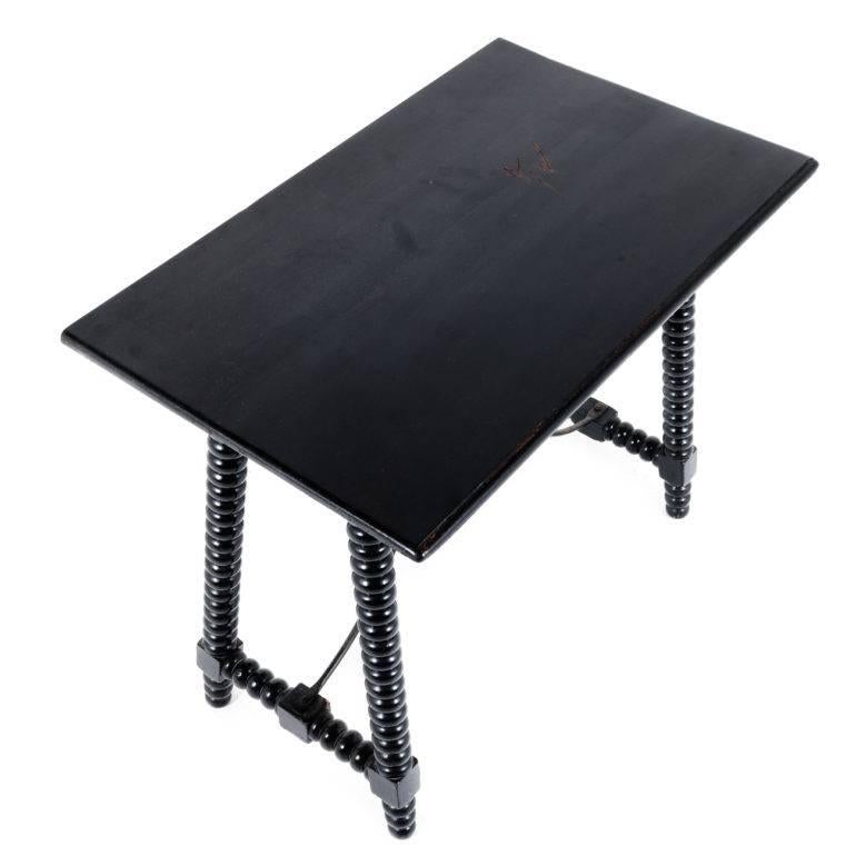 French ebonized table with bobbin-turned legs and wrought-iron stretcher base, circa 1900.


