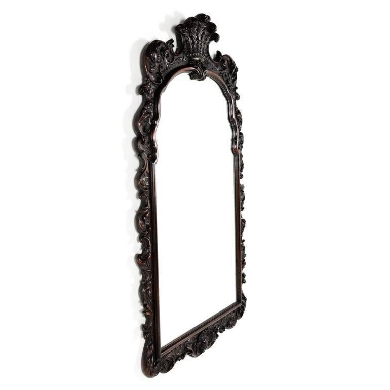 Profusely carved antique mahogany framed mirror with Prince of Wales Feathers. Circa 1880.


