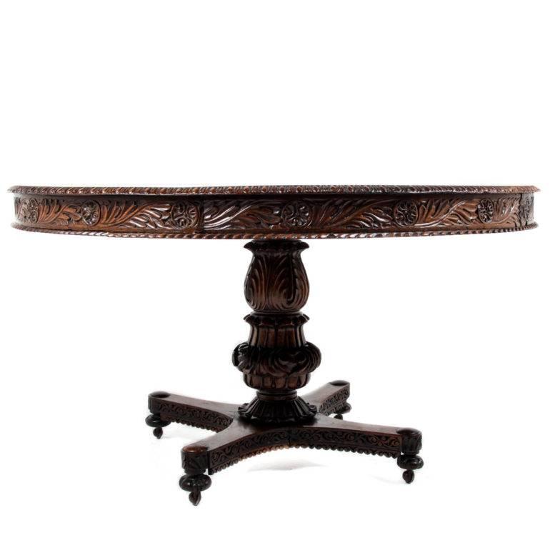 A large, round, rosewood tilt-top centre table, circa 1860. Highly carved.

An impressive example of ‘Anglo-Indian’ furniture, the tilt-top pedestal form is British in design, but the rosewood timber and ‘busy’ carving are typical of a piece made