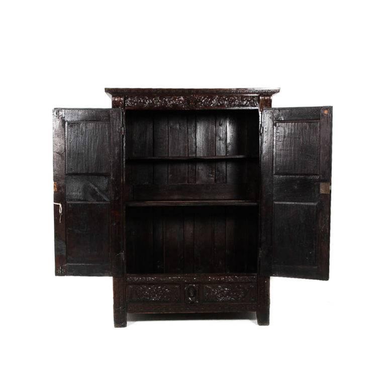 19th century French antique armoire. Highly carved, solid oak, and very deep suitable for clothes hanging or TV-and-component storage. Small-scale, will fit in any room. 



