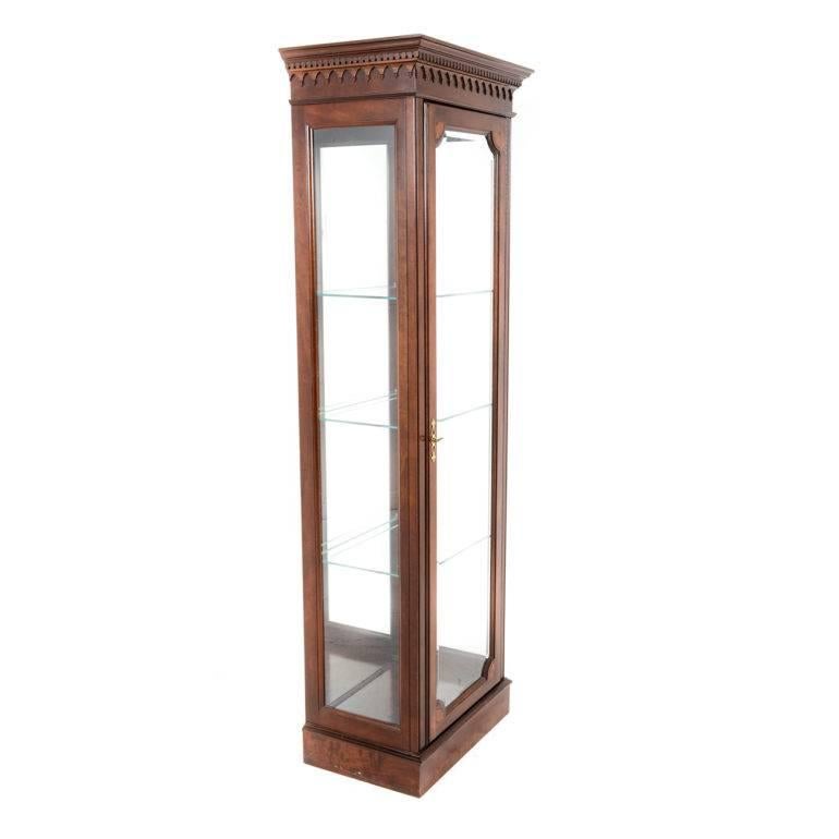 Tall Georgian style vitrine with three-glass shelves and mirrored back. Unique, compact size makes it very versatile around the home.

