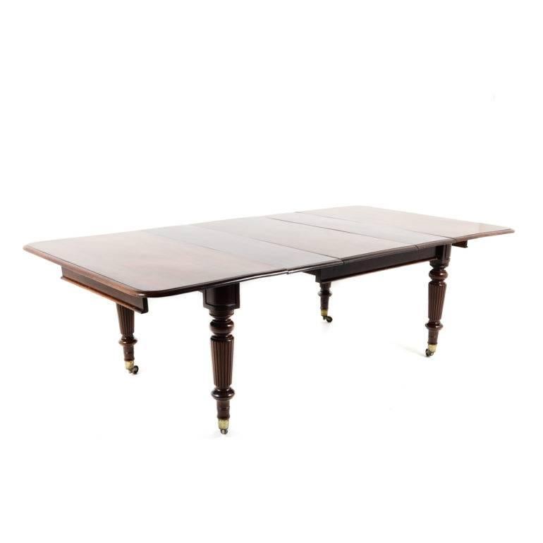 Antique English mid-Victorian mahogany dining table, extending with three leafs. Unusual width on this lovely table with deep rich color.

Measure closed: 52” wide x 49.5” deep x 30” tall.
With three leafs installed - 97” wide.

