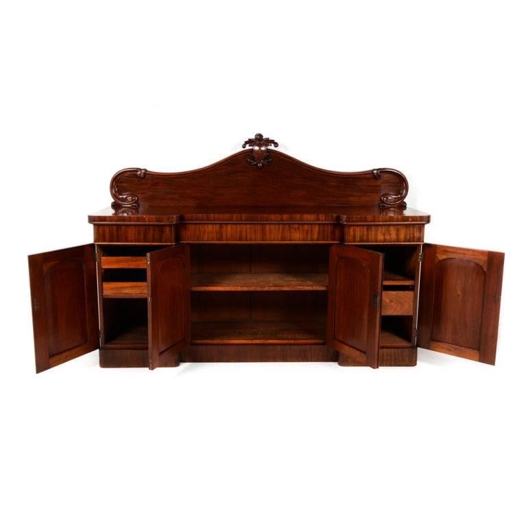Grand and impressive antique English Victorian mahogany breakfront sideboard with dramatically-carved back. More than ample storage with lovely shelves and drawers. Could be the centrepiece for an elegant dining room.


 