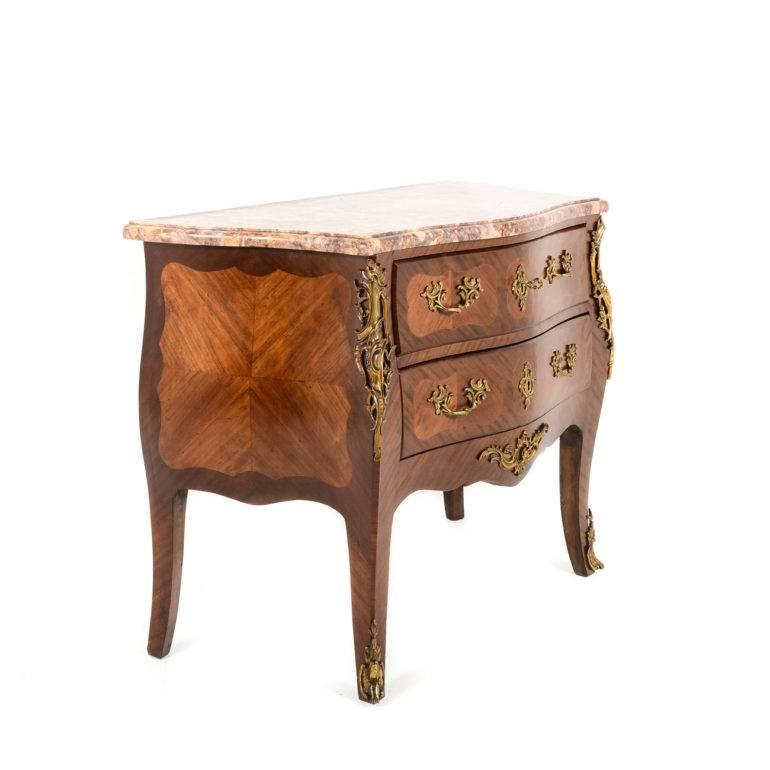 Antique French 1920's bombe commode, with double-edge marble top. In superior condition with elegant and crisply-detailed bronze ormolu mounts.


 