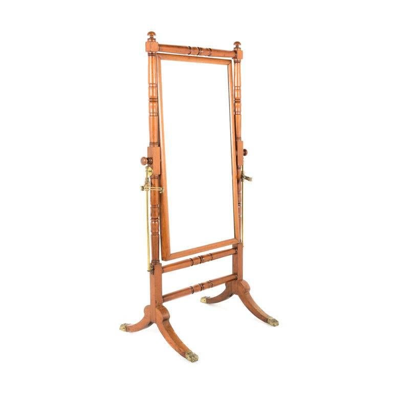 Antique English Regency mahogany cheval mirror, with brass feet and swivel. Original brass adjustable candle ‘arms’ on each side (but missing actual candle holders), circa 1825-1830.



 