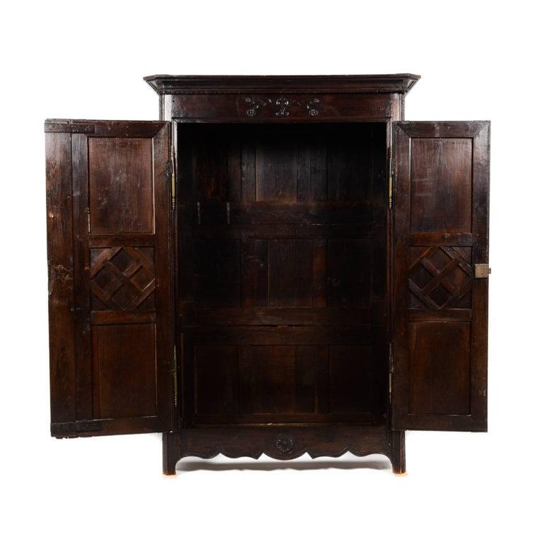 Antique French, carved chestnut, two-door armoire. Dark patina and contrasting hardware enhance this piece. Circa 1850-1870. Shelving and/or hanging-rod can be provided.


 