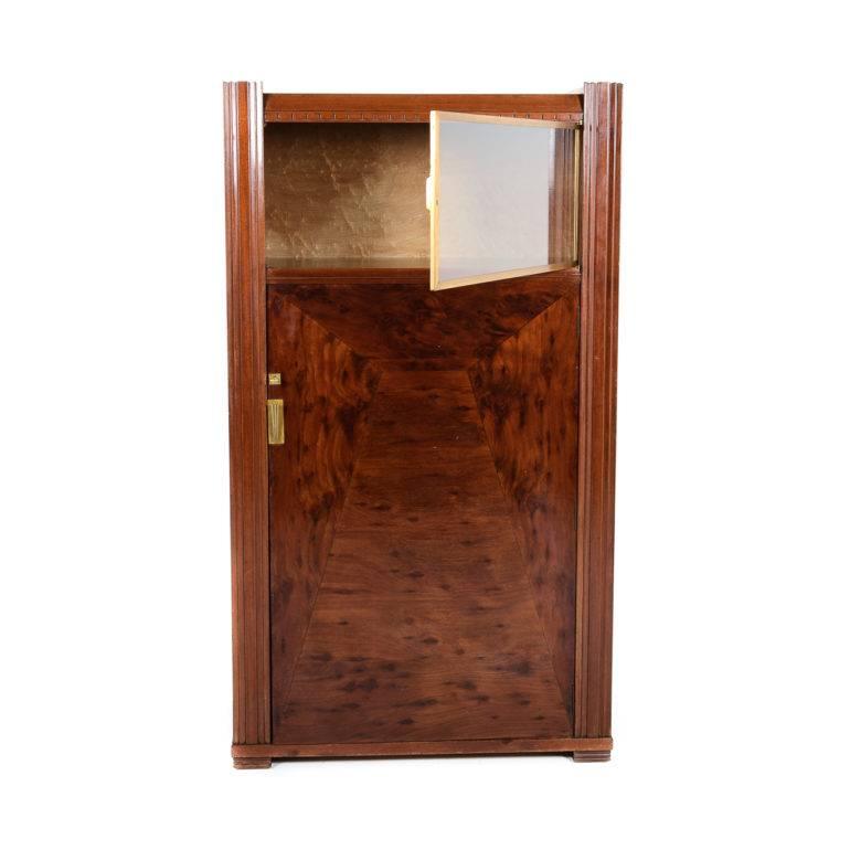 An excellent quality, French Art Deco cabinet from Paris, circa 1930. This piece is constructed of solid woods and veneered with plum-pudding mahogany. It has a satinwood-lined interior, and is beautifully finished with bronze detailing.


