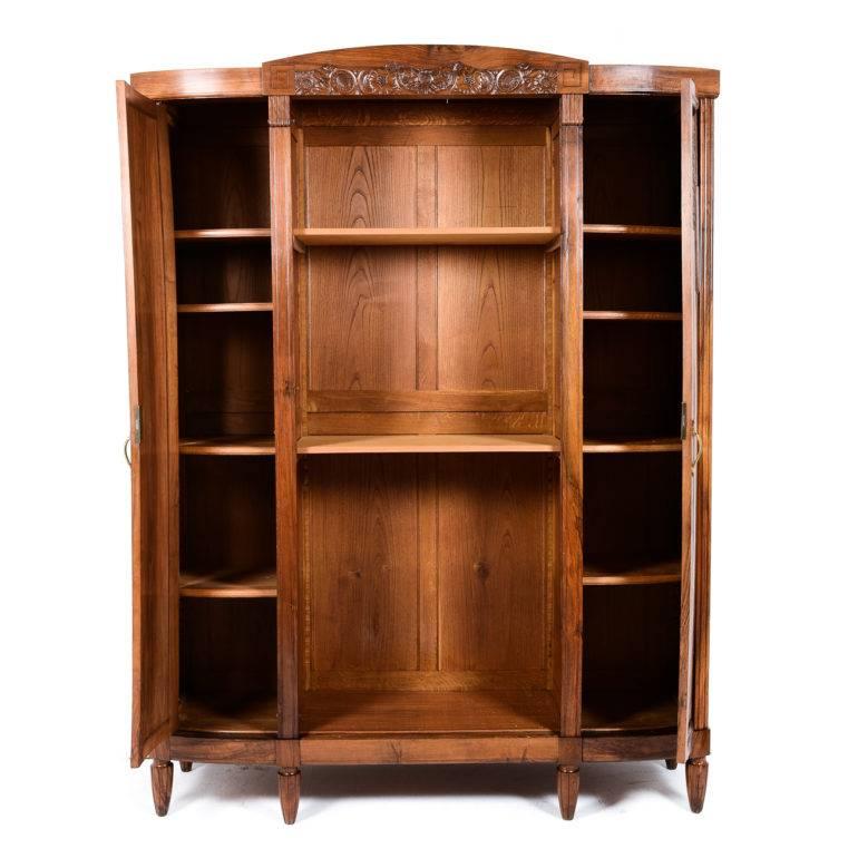 Large solid walnut French Art Deco cabinet. Originally with a centre door, now open shelving flanked by two enclosed sections with solid walnut-carved doors. More adjustable shelves can be produced for the centre section. It would also make an