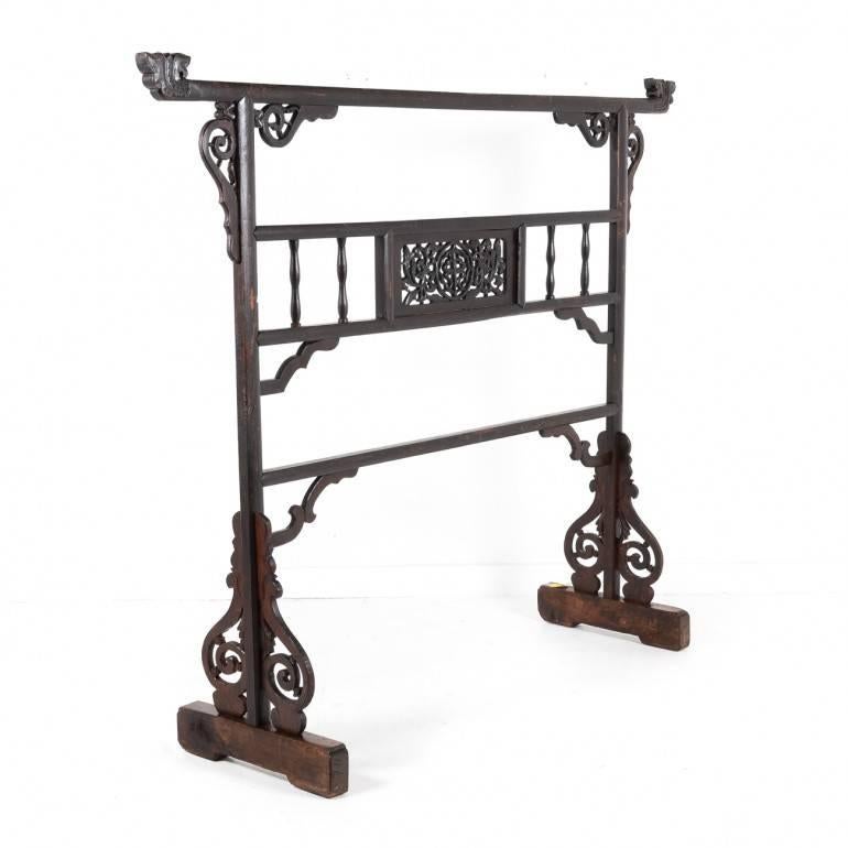 This is a traditional Ming dynasty-style, 19th century, Chinese garment rack, made of Hualimu – also called Rosewood. It comes with open-work carving of double-dragon chasing a ball. At night, Chinese nobles tossed their discarded robes over a