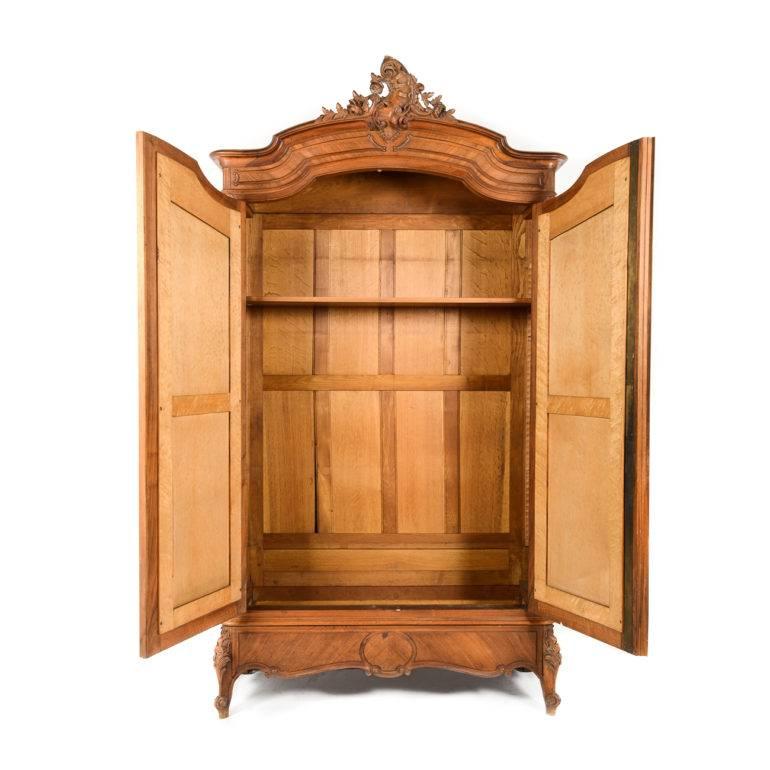 Rare antique two-door hand-carved late 19th century walnut and marquetry Louis XV style armoire, circa 1880. Measures: 54.5” wide x 20.5” deep x 101” tall.