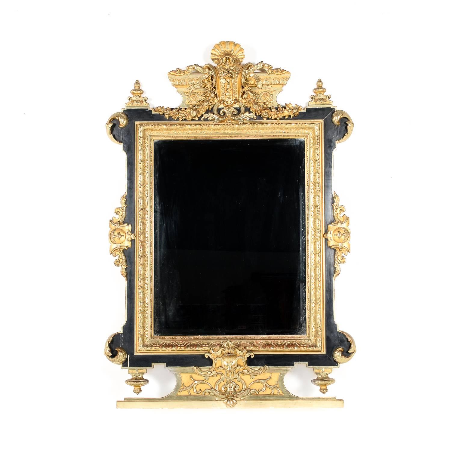 A large and impressive – almost 5′ tall – 19th Century black-and-gold Napoleon III wood mirror. Superior quality and excellent detailing.

