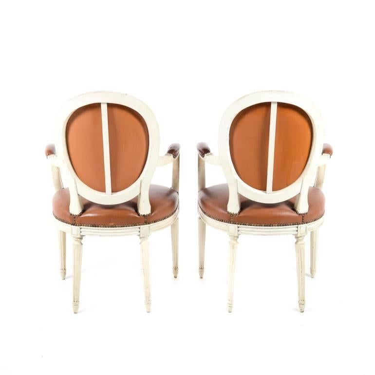 Matched Pair of Painted and Leather Louis XVI Style Armchairs, circa 1950 In Good Condition In Vancouver, British Columbia