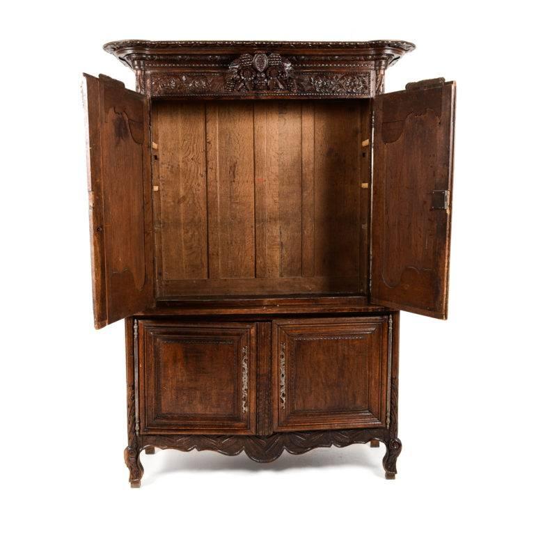 Antique buffet Deux Corps from Normandy, circa 1830. Beautiful patina and highly carved oak with ornate brass escutcheons. Its 22