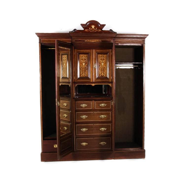Beautiful quality on this fine English combination wardrobe, with two doors, banks of drawers, and gorgeous inlays of ivory and kingwood. A unique look to an armoire, which is equally at home in the dining room as a china cabinet as it is in the