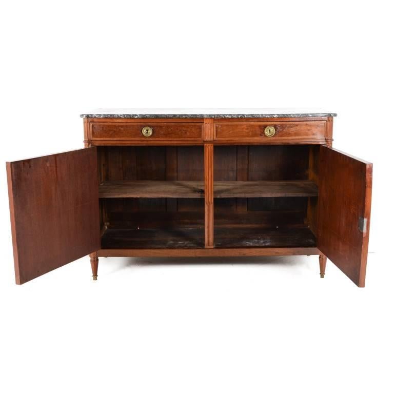 19th century French mahogany Directoire-style buffet. Clean lines, striking marble top, subtle brass locks, and a gorgeous patina all combine to make this a very fine piece. Its narrow depth also makes it a good candidate for any number of rooms in