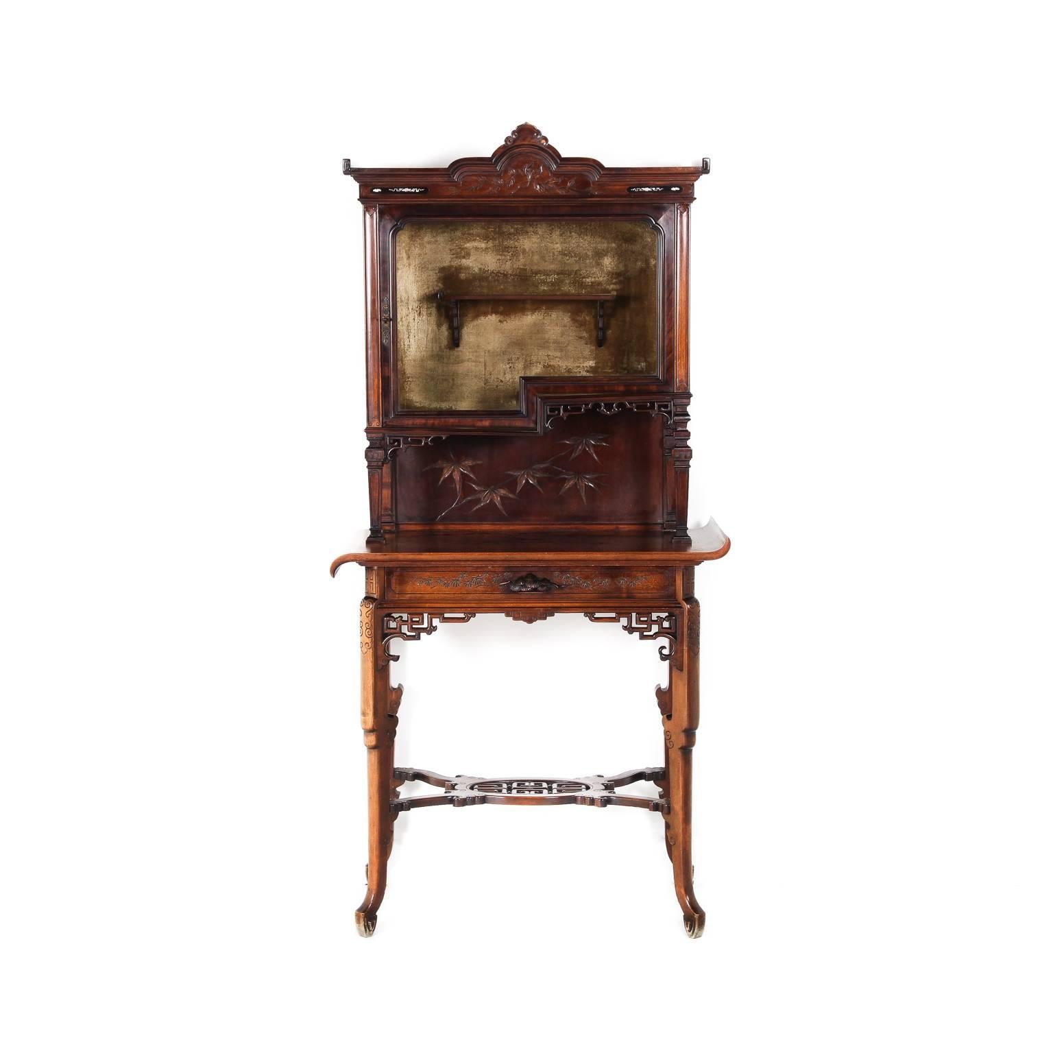 A very unusual Chinoiserie vitrine, or display cabinet, in the manner of Gabriel Viardot. The display top is carved and inlaid with mother-of-pearl and raised on elaborately pierce-carved legs. French, circa 1890.

Gabriel Viardot (1830-1906) was a