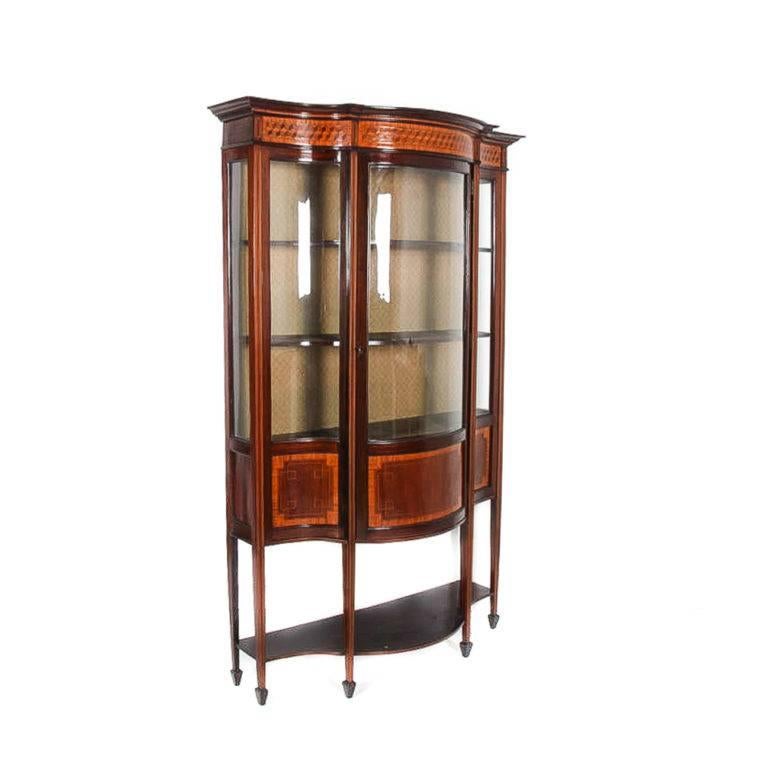 Beautiful early 20th century Edwardian china cabinet in excellent original condition with its original curved glass. The inlay and marquetry - in exotic boxwood, ebony, and kingwood - is quite exquisite on this piece. Would enhance many different