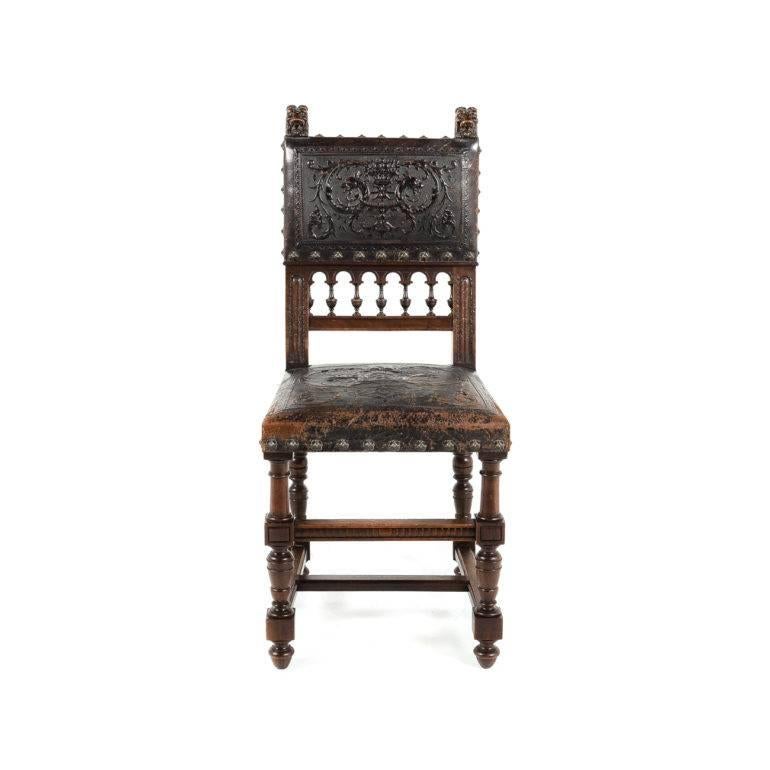 Antique set of eight Renaissance Revival dining chairs. Walnut, with embossed leather on back and seat, highly carved with a lion motif and brass decorative studs. Sturdy and suitable for everyday use. Circa 1870.




 
