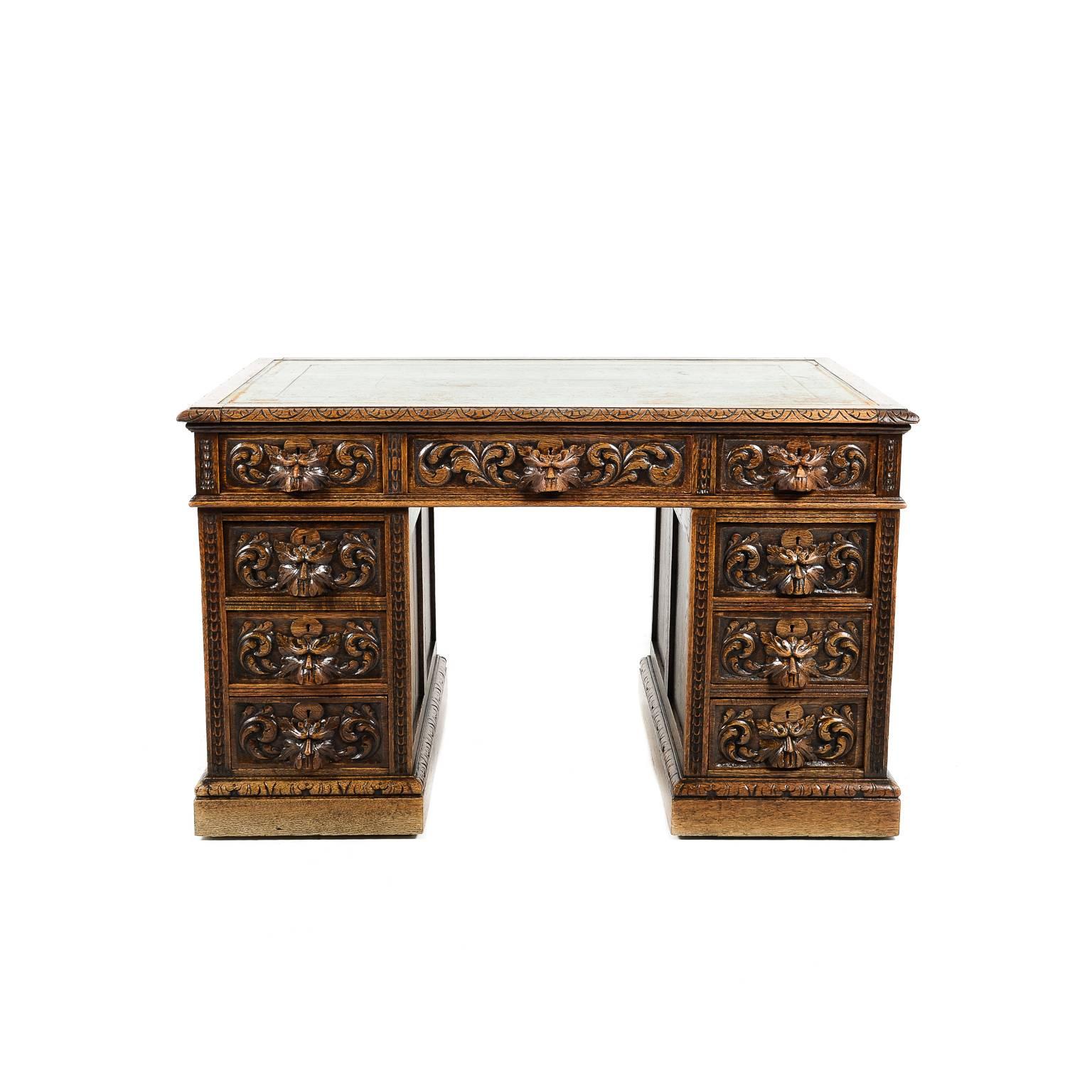 Antique English late Victorian, intricately carved oak desk with the original gilt, hand-tooled leather top, circa 1890.





 
 