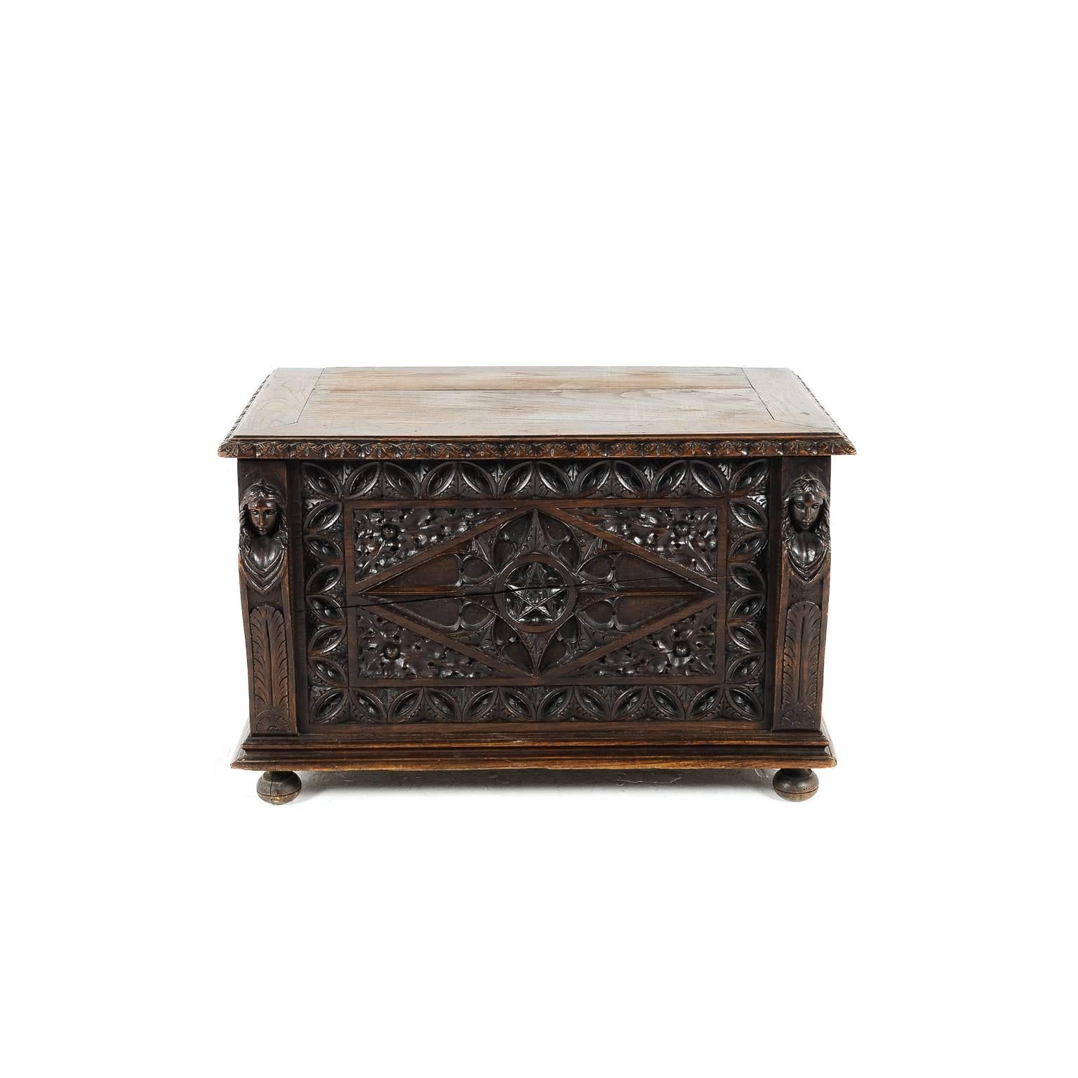Small carved French coffer, in various woods, including elm, pine and oak. The carvings are nicely intricate and the patina is rich and dark. Its small size makes it ideal for a number of different locations and rooms in the home, circa 1880.





 