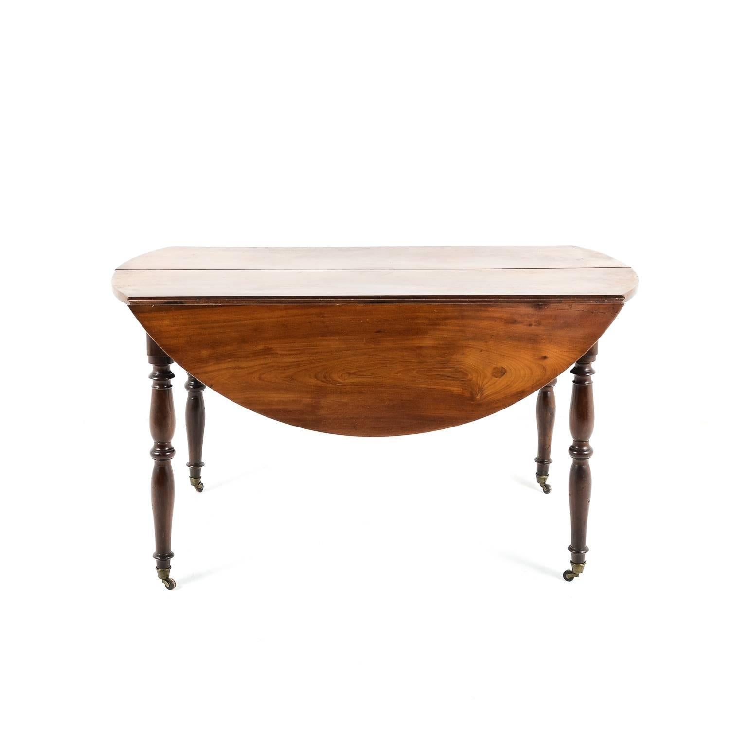 Gorgeous French polish and patina on this beautiful 19th century French fruitwood drop leaf table. Measure: 51” wide x 50” deep (leaves up) x 28” deep (leaves down) x 28.5” tall.
 