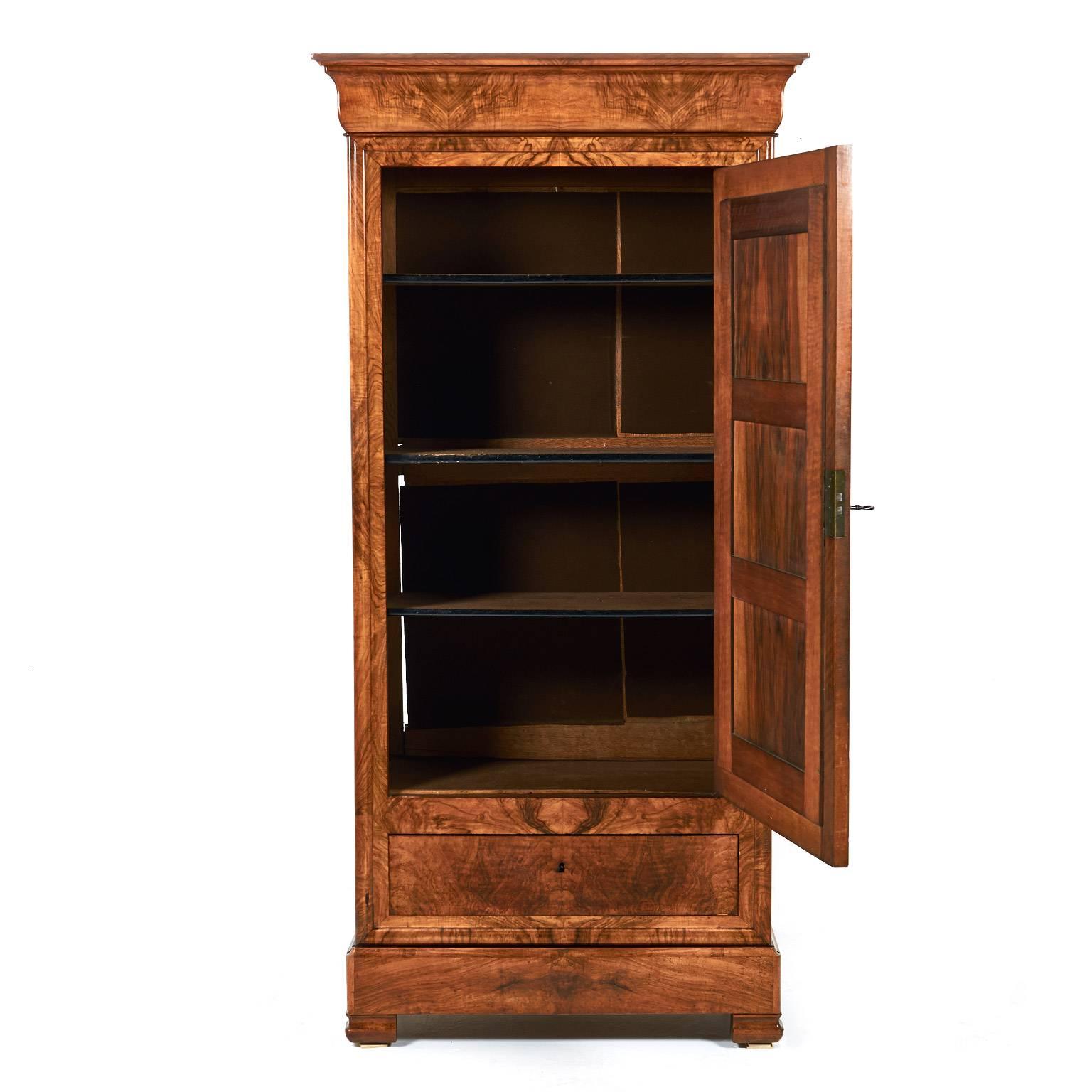 Antique French burl walnut Louis Philippe mirrored door armoire, with adjustable interior shelves and two drawers below one obvious and one hidden in the base. An unusually-compact version of a Classic mid-19th century French design, circa 1870. Its