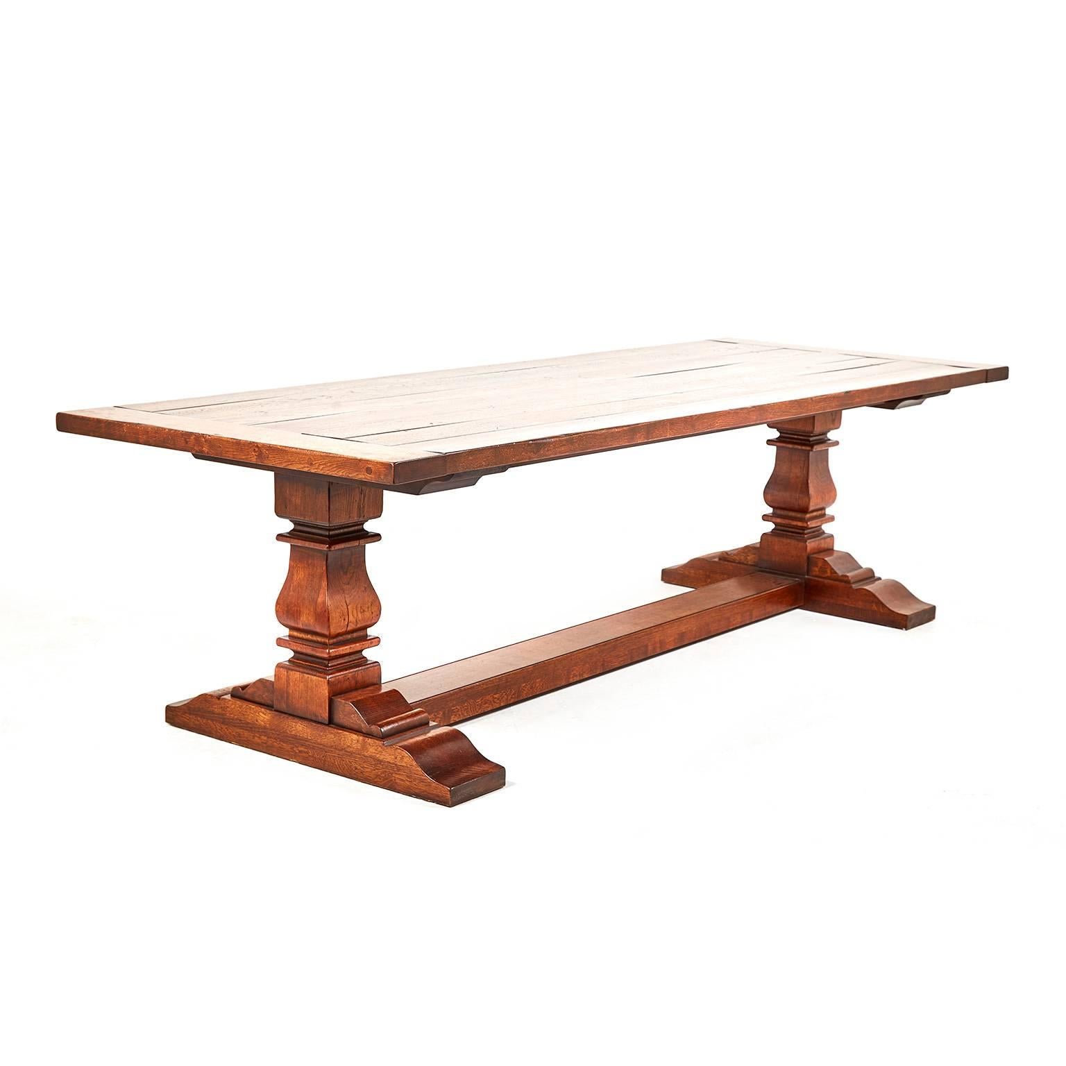 At 9 feet long, this is an unusually-large and fine-quality ‘refectory’ or trestle table, English-made and solid white oak throughout. Although the quality of construction and patina suggest an older piece, this is relatively new table and heavy,