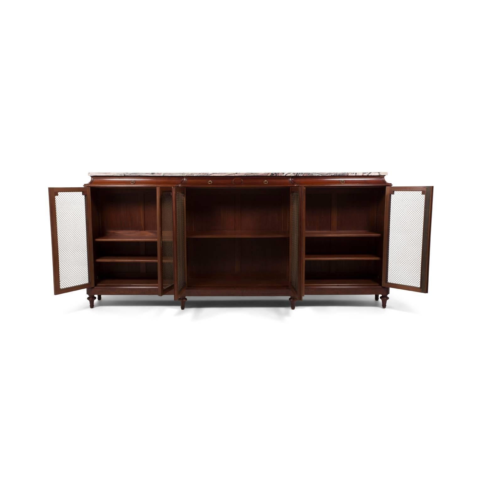 A most impressive mahogany bookcase almost 10 feet in width. Six doors with gilt mesh covers. A spectacular single, continuous piece of marble on top. This is truly an imposing piece that serve as the focal point in an office, living room, or dining