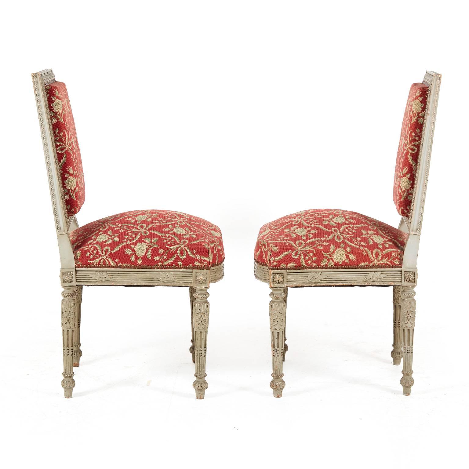 Set of two Louis XVI carved chairs, circa 1780. These are period Louis XVI pieces and the detailing is superior and expertly hand-carved maple. Hand-embedded studding around the upholstery. These are a must-see and have recently been