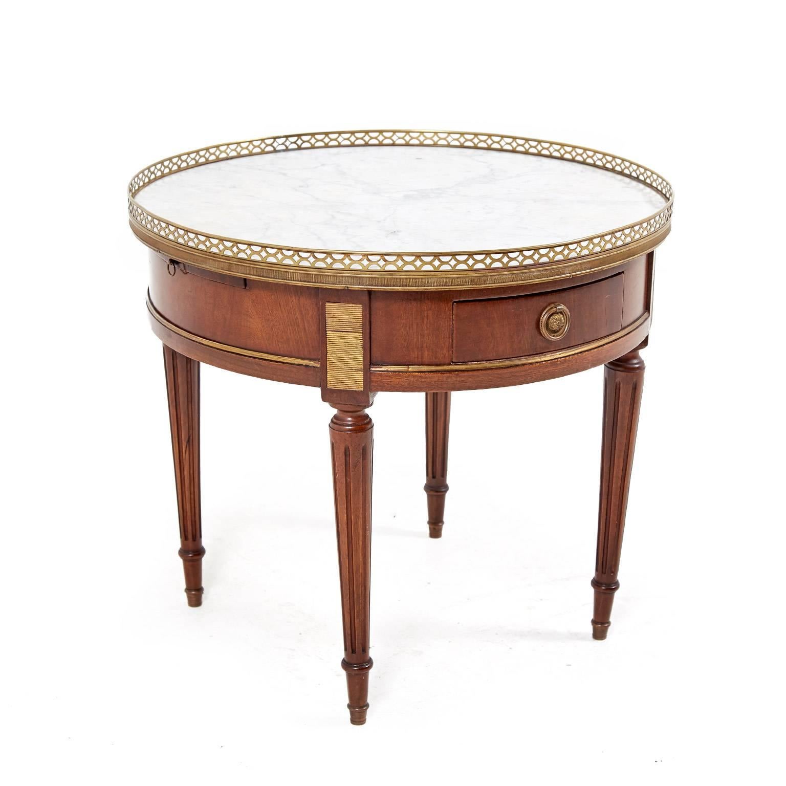 Small French marble-top, Louis XVI-style, round mahogany coffee table with two drawers and two pull-out surfaces. The marble is enhanced by a delicate brass gallery, circa 1920. Its perfect size makes it ideal for any number of locations throughout