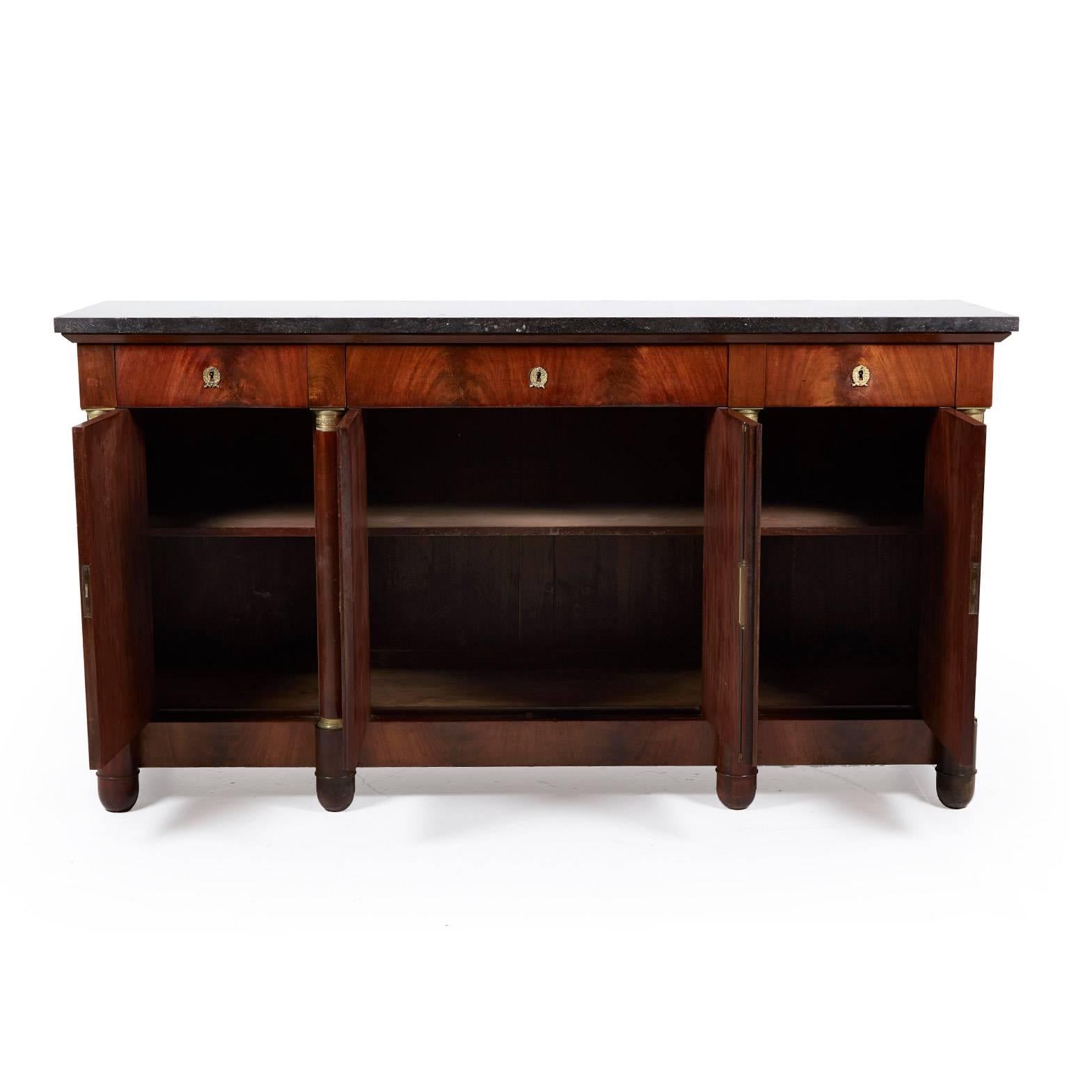Antique Empire-style mahogany sideboard with columns and marble top, circa 1910. With lovely brass accents, the marble enhances the richness of the mahogany patina.




          