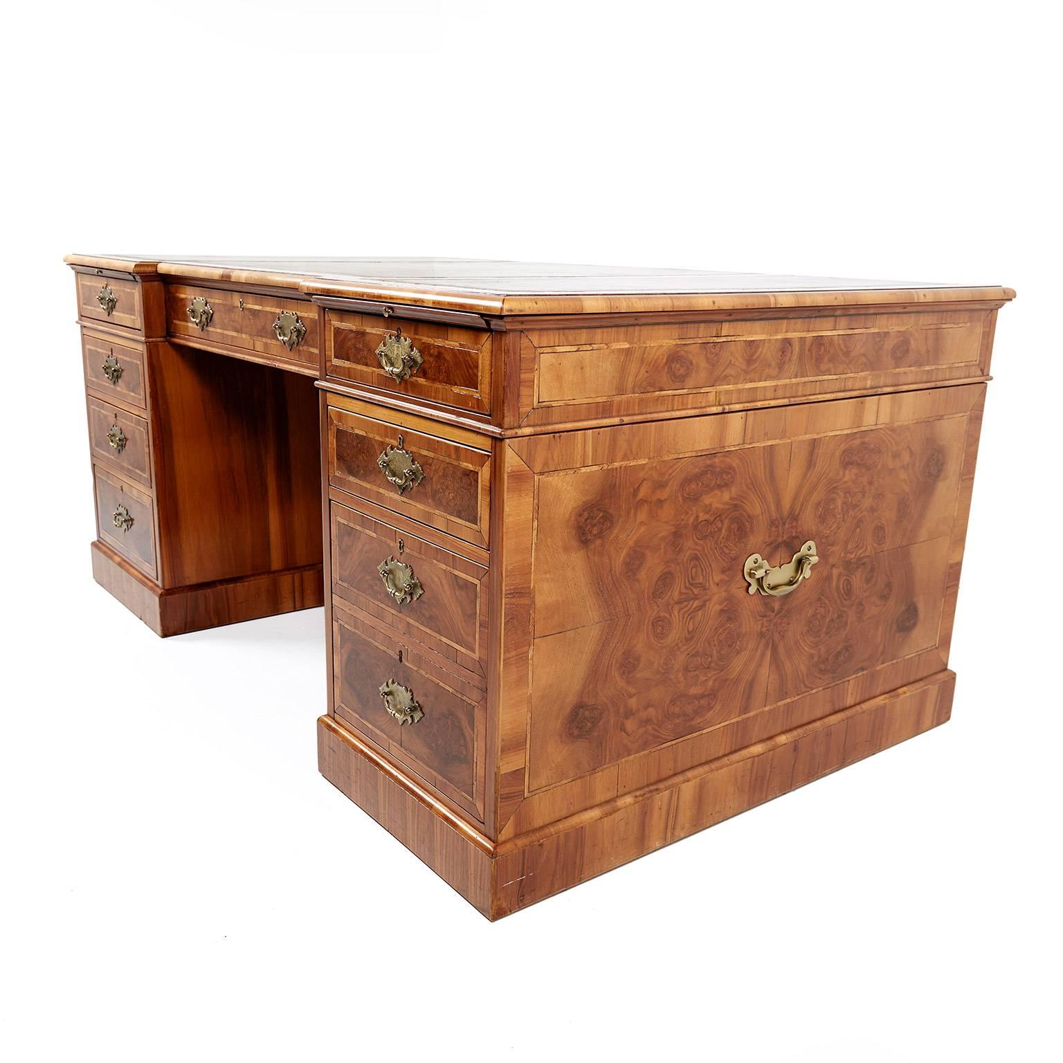 Large antique English walnut double-pedestal desk. The drawers and panels are veneered in burl walnut with herringbone inlays. Original leather insets and finished on all sides, circa 1920.


 
      