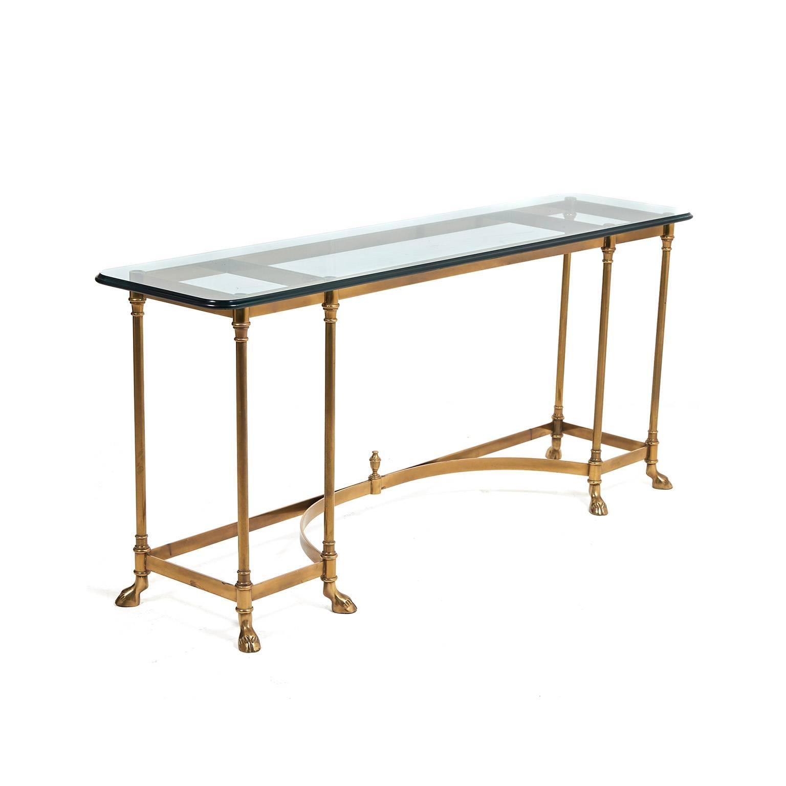Vintage solid brass and glass-top console with unusual ‘hoof’ feet. Its shallow and low dimensions make it ideal as a sofa console or even a TV stand. 20th century production. Glass is a full .5? thick.



    