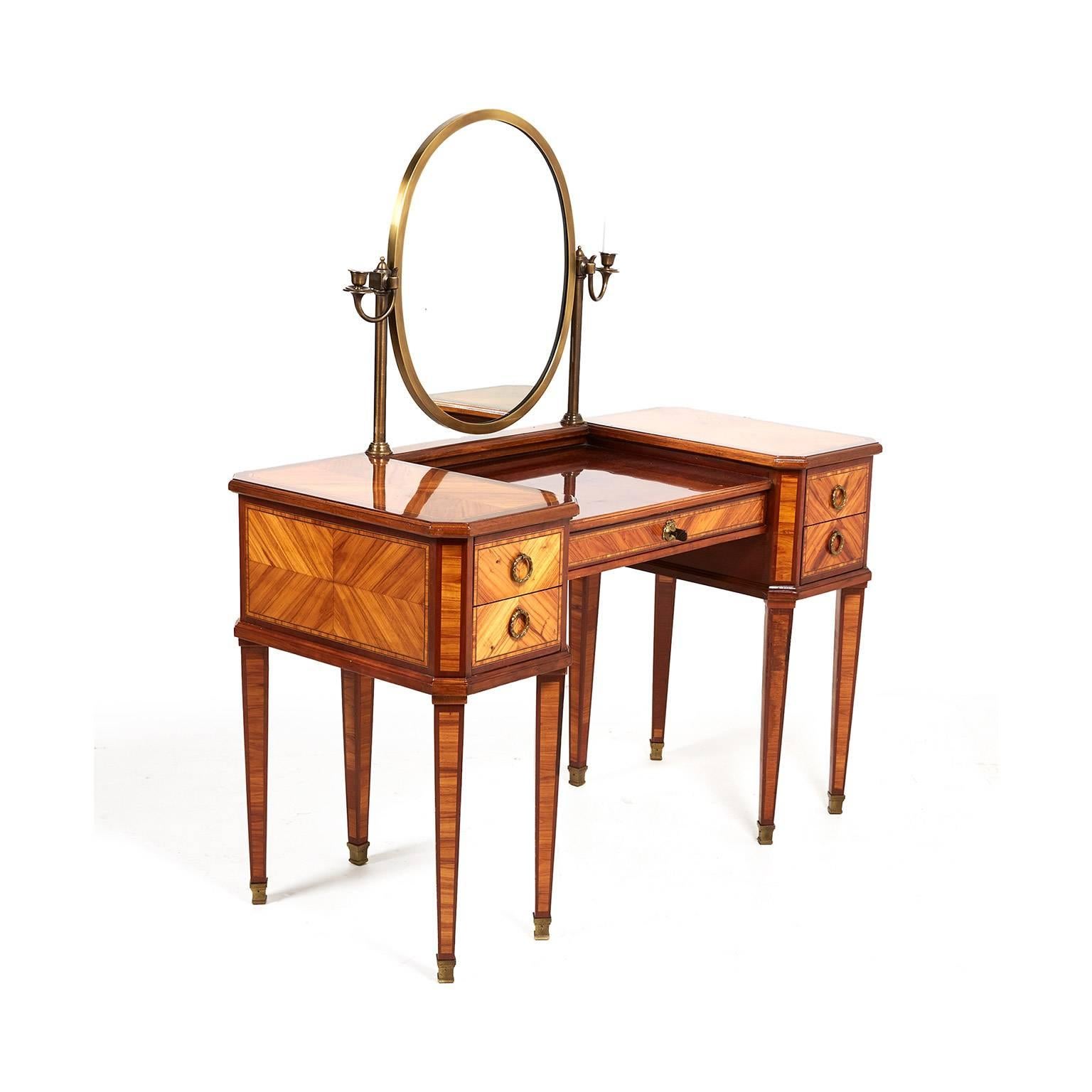Antique mid-20th century highly inlaid mahogany and kingwood French vanity with a brass-framed mirror enhanced on either side by a pair of brass sconces. From the Le Bristol Hotel in Paris. (Original Le Bristol Hotel paper still in one of the