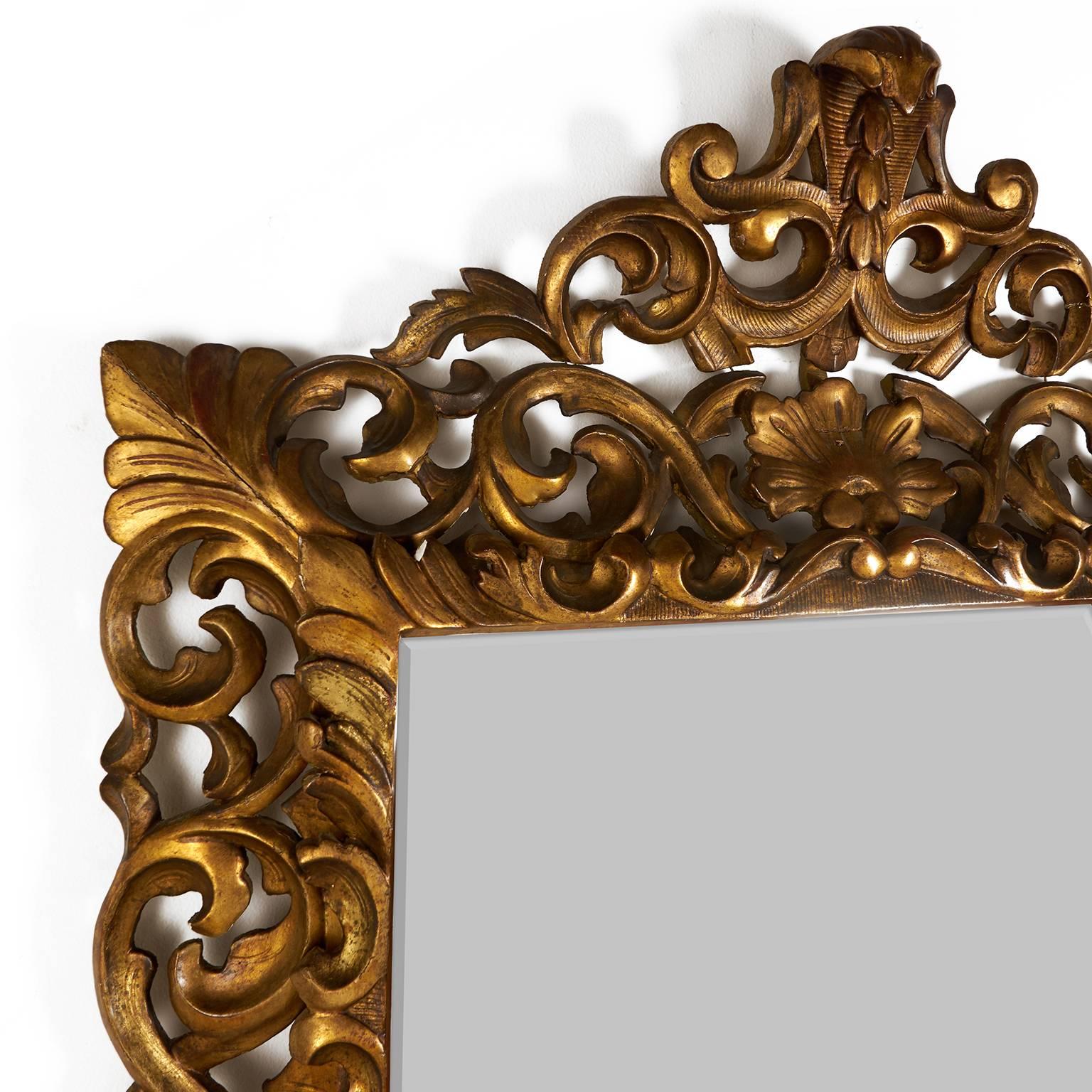 A boldly pierced and carved giltwood frame surrounding a bevelled mirror. French or possibly Italian, circa 1920.



