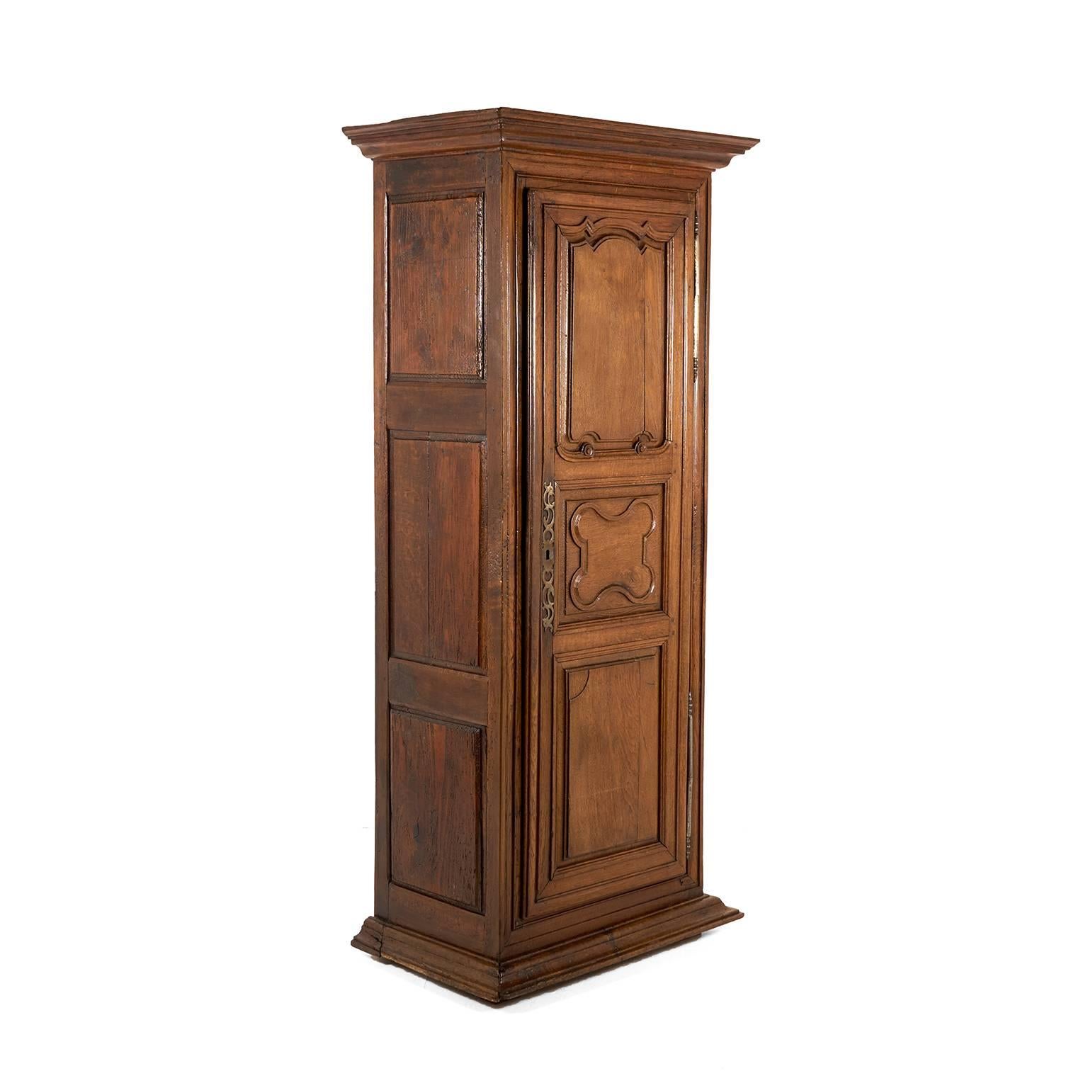 A rustic French single-door armoire or ‘bonnetiere’ with raised solid-oak paneled door and sides, and fitted with shelves and a drawer to the interior, circa 1860.


Measures: 31? wide (Top) x 22? deep (Top) x 75? tall.

