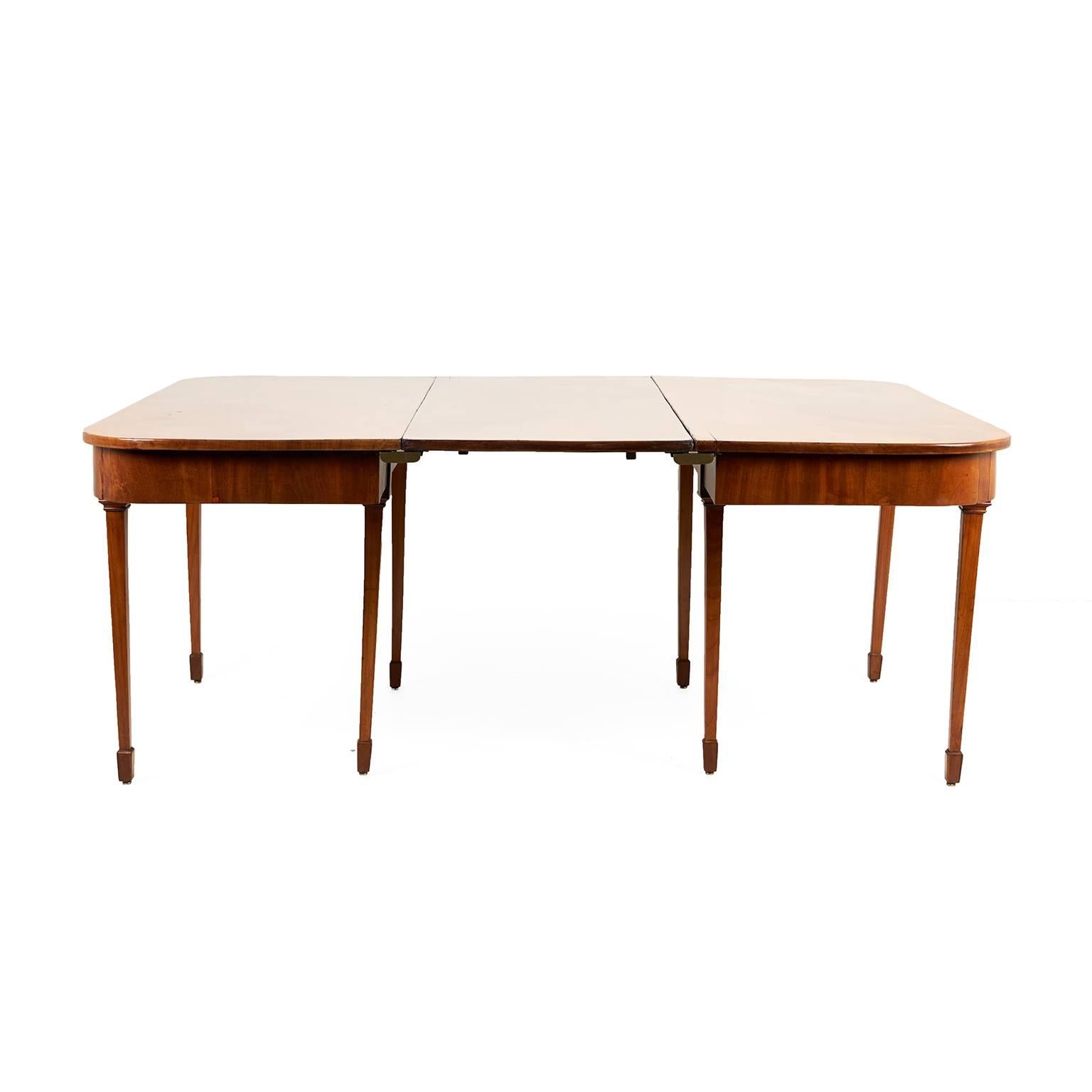 An English Georgian dining table, comprised of two ‘D’ ends, with a single.
circa 1820.


Measures: Each ‘D’ end: 52 inches wide x 24 inches deep x 28 inches tall. Leaf is 20 inches.
Table with leaf in: 68 inches wide x 52 inches deep x 28 inches