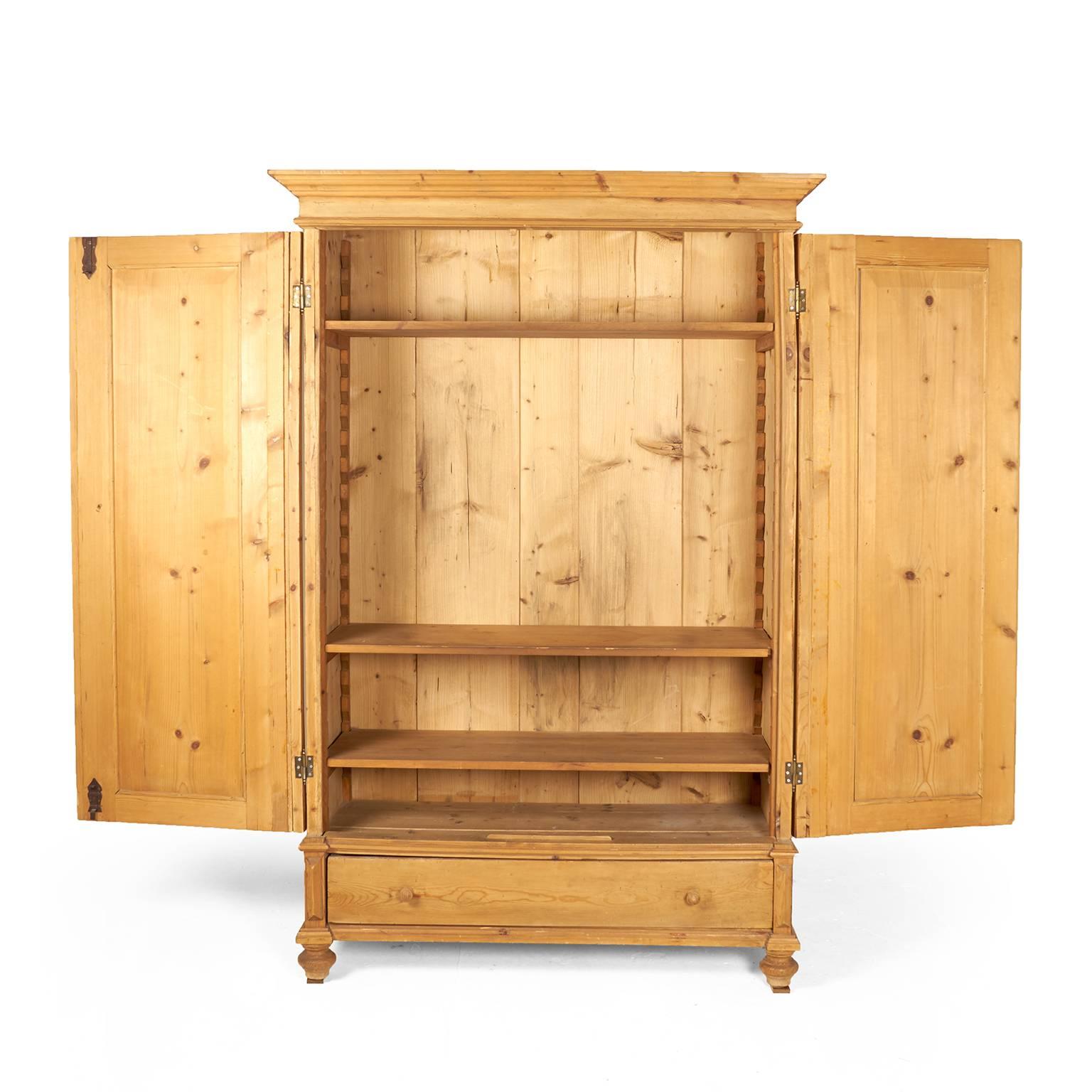A late-19th century Continental European two-door pine armoire with space for hanging or shelf storage above, and a small drawer below, circa 1890.



       