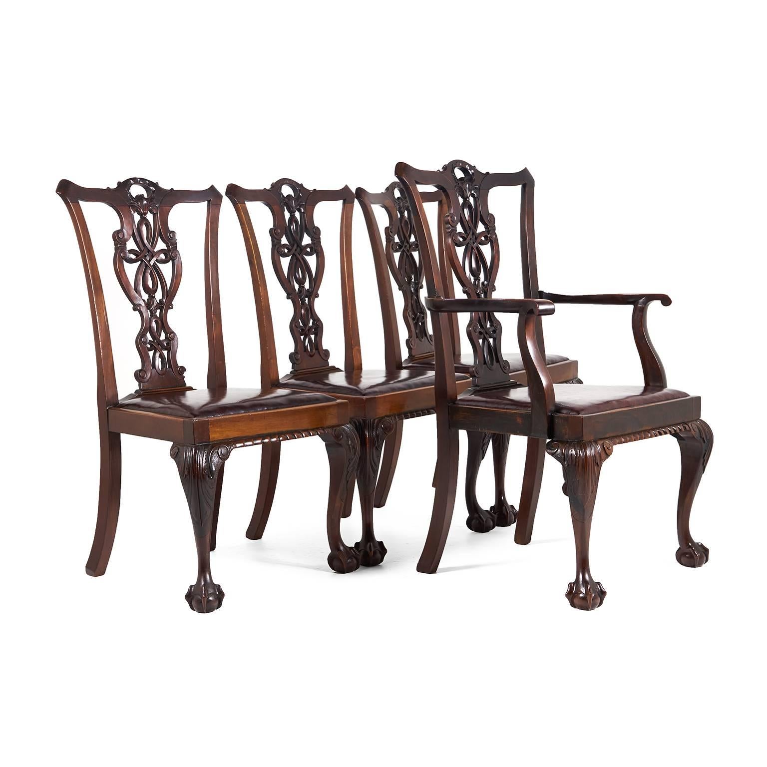 A set of excellent quality Chippendale-Revival ‘ribbon back’ dining chairs in mahogany.

Three side chairs; one armchair. English, circa 1900. Gorgeous patina on these pieces, and they're sturdy enough for everyday use.

Measures: Sides: 23?