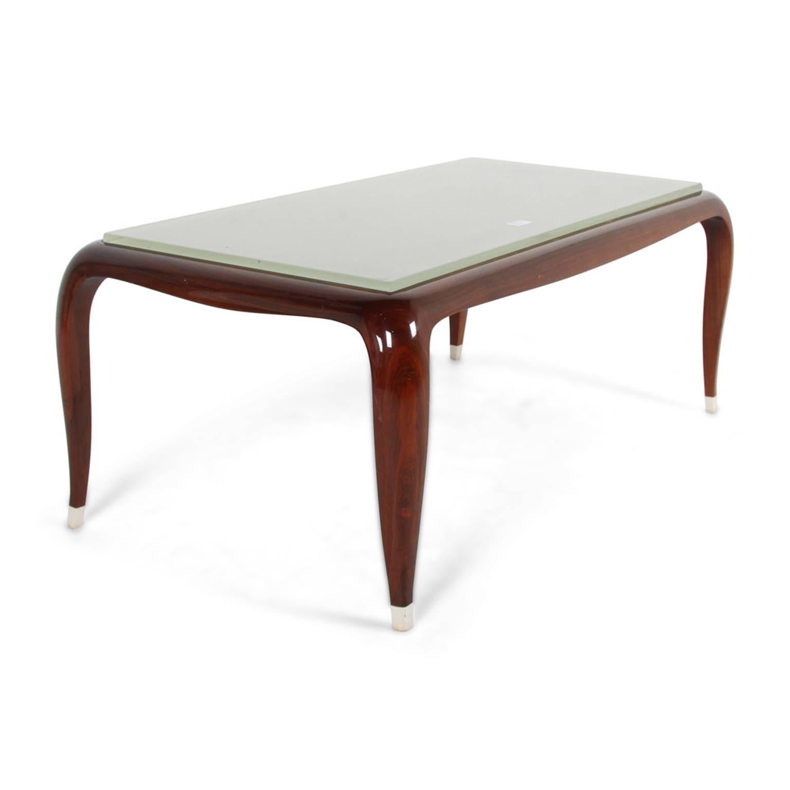 An elegant French Art Deco-style coffee table in rosewood, with faux ivory feet and an etched glass top. Circa 1960.




