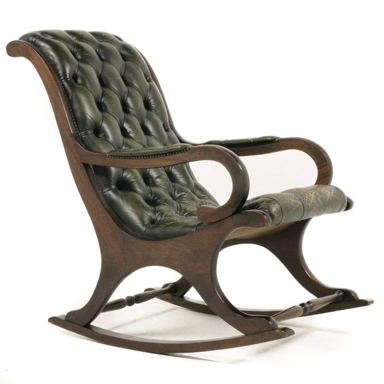 A vintage English, button-tufted, leather upholstered rocking chair. Circa 1950.



