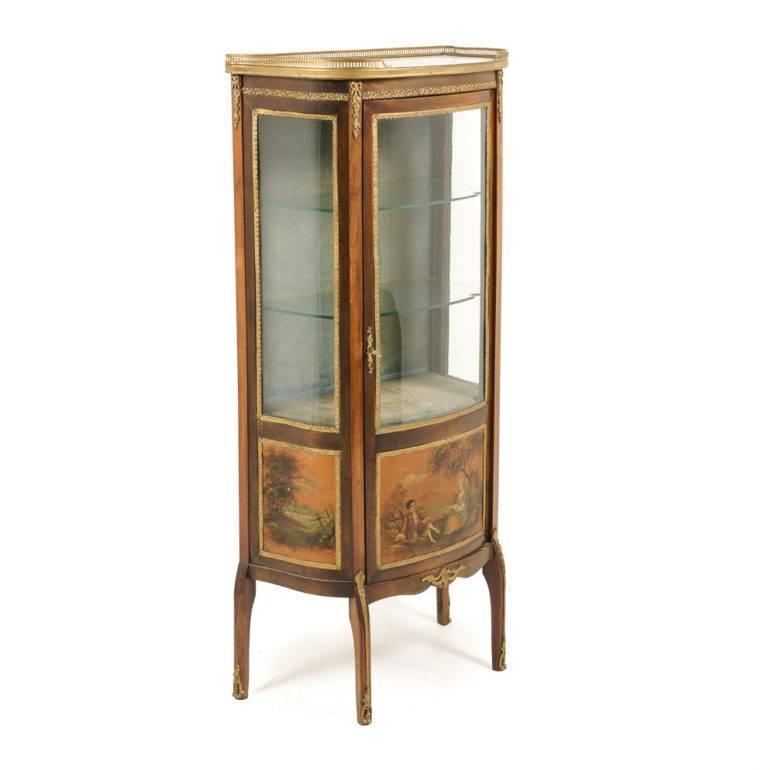 A lovely, hand-printed and rare, superior quality French Louis XV-style display cabinet from Paris. Exceptional original condition, with gorgeous detailed mounts, and a contrasting slab of marble surrounded by a pierced brass gallery. Circa 1920.



