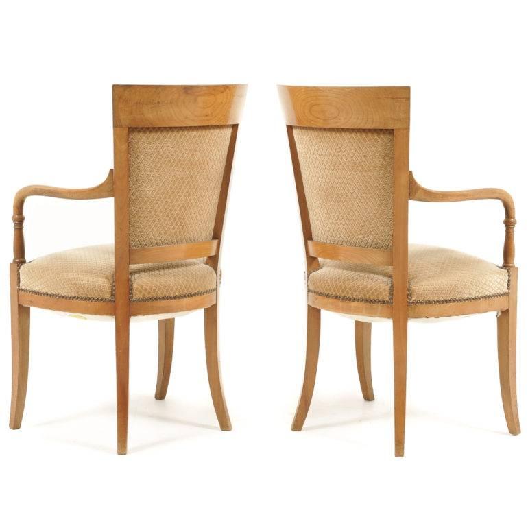 A pair of French Empire-style cherrywood armchairs, circa 1930.
 