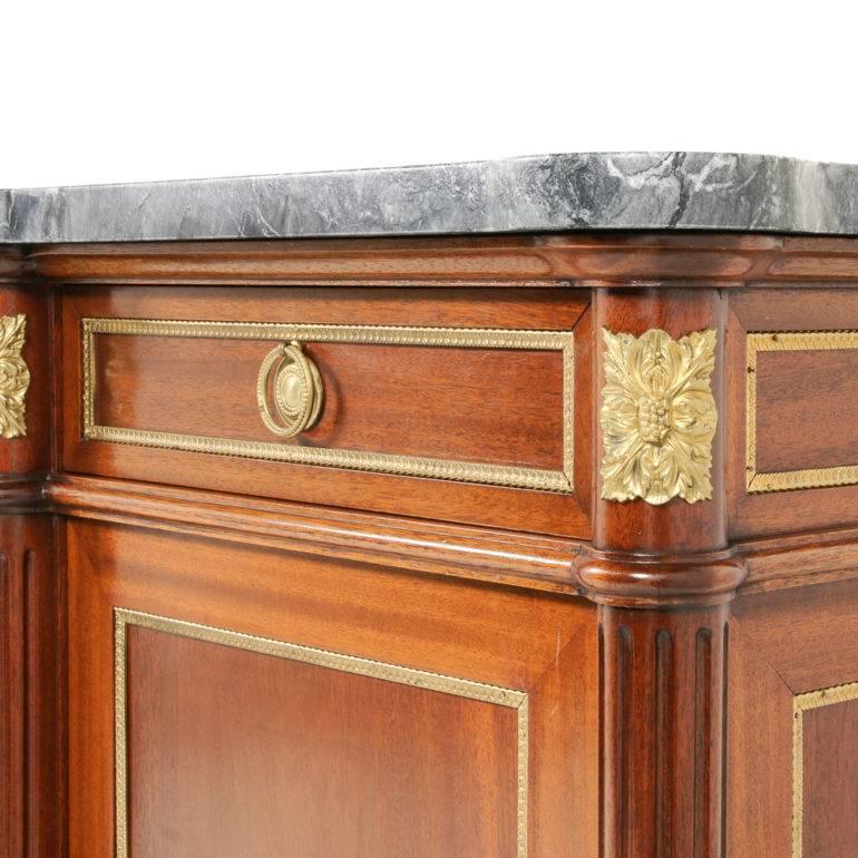 A large and impressive French Directoire-style, marble-top, breakfront buffet in mahogany, having four drawers over four doors and embellished throughout with gilt bronze mounts, circa 1950.



 