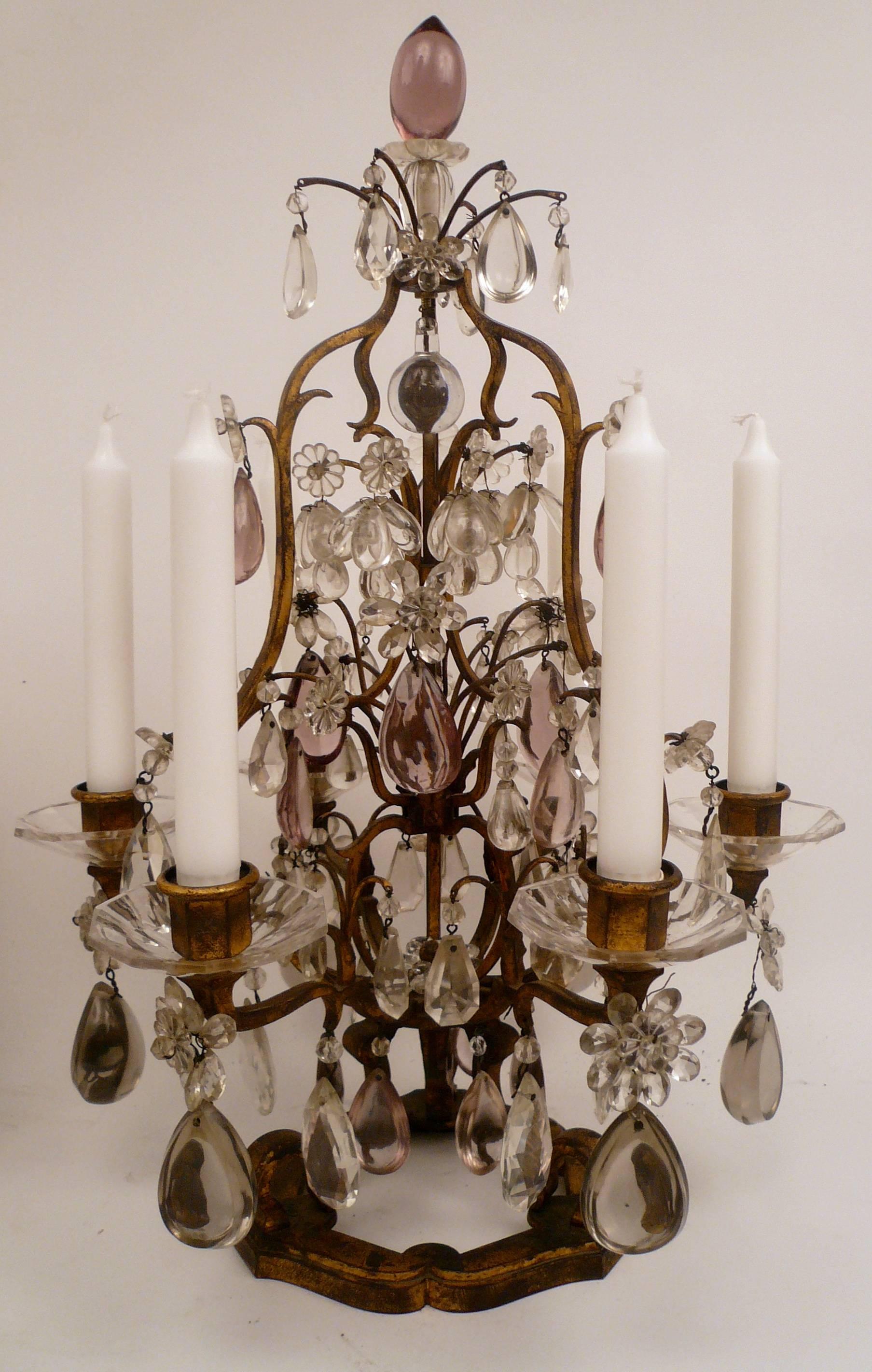 This fine pair of six light lustres in gilt iron are hung with smoke, amethyst, and clear cut crystal prisms. 