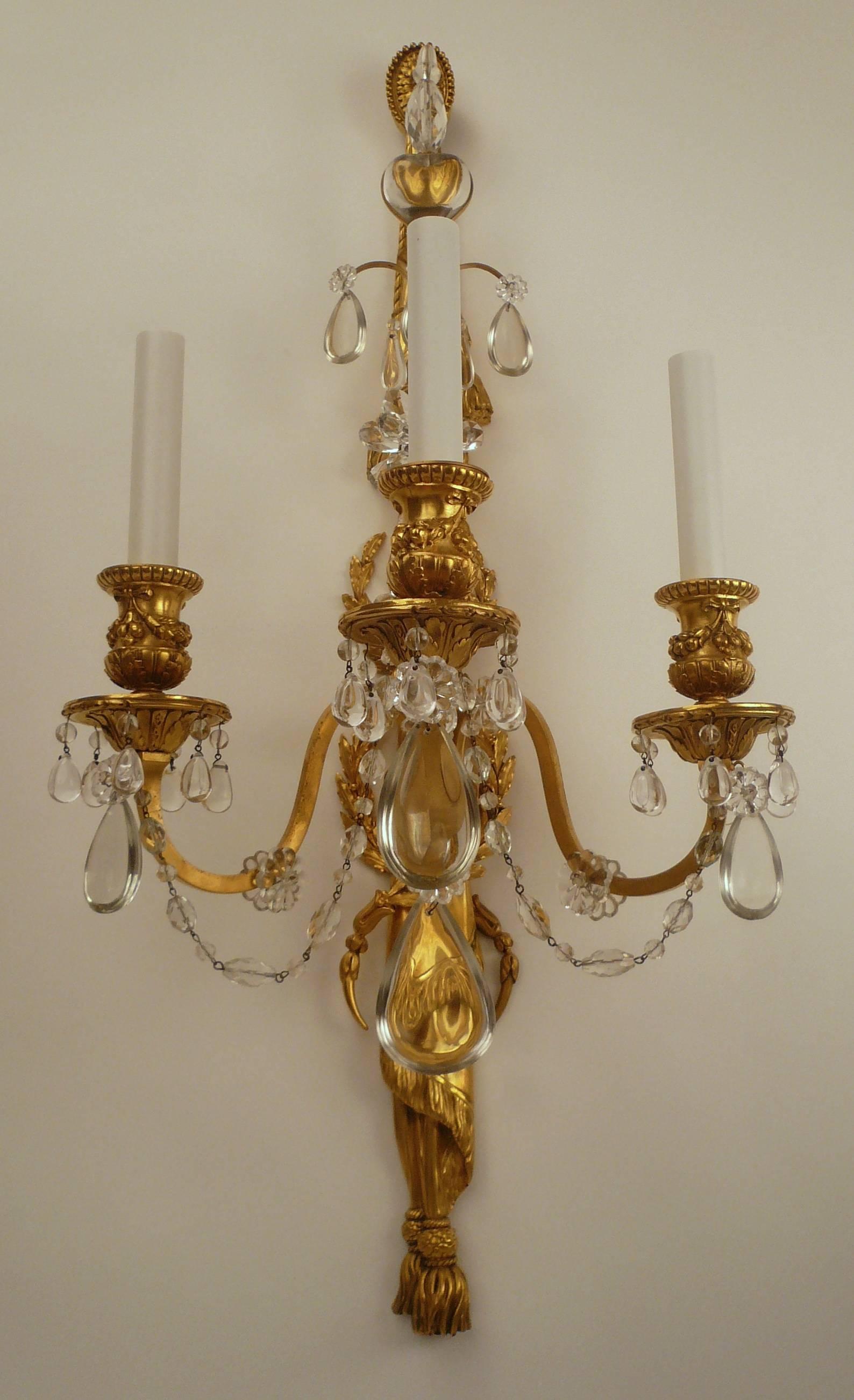 These fine quality neoclassical style sconces have their original gilt bronze finish.
They are beautifully cast and hand chased, with drapery and tassel motifs.