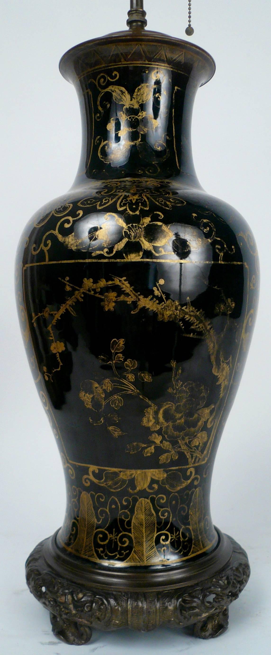 This gilt decorated mirror black glazed porcelain vase was mounted as a table lamp in the 1920s.