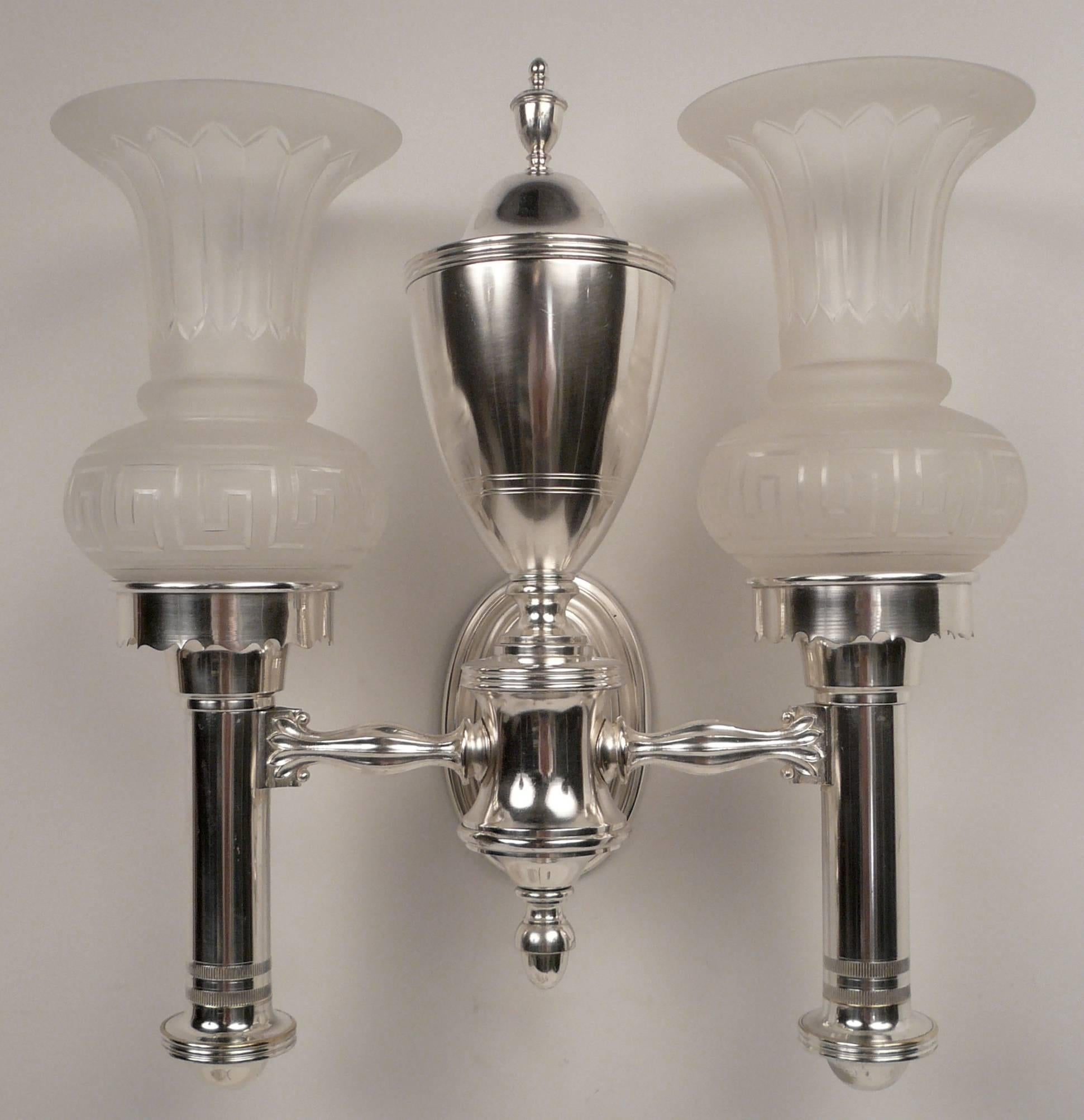 This handsome set of four silver plated sconces are beautifully crafted and date from the early 20th century.